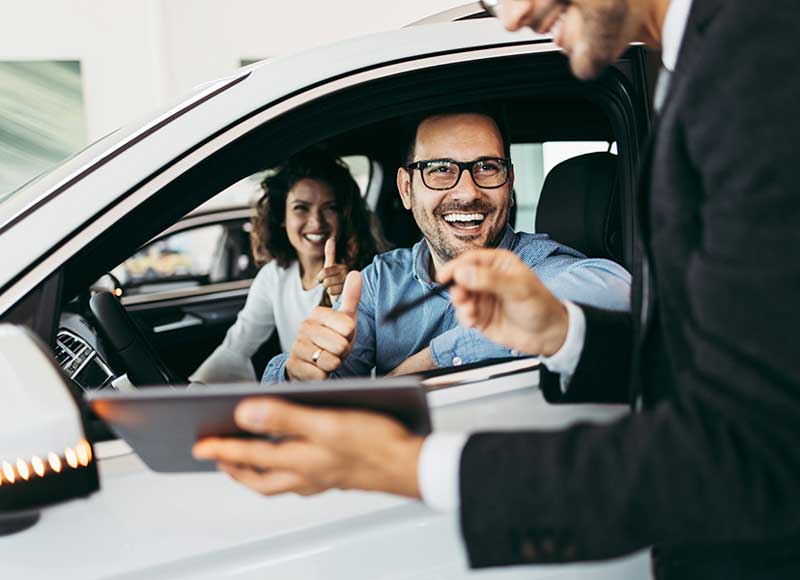 couple in car smiling at salesman Stevens Point Hyundai in Stevens Point WI